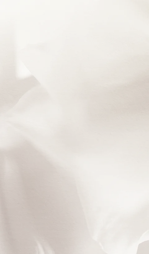 An abstract, high-key background featuring soft, flowing white fabric or paper with subtle shadows, creating a clean and airy aesthetic.